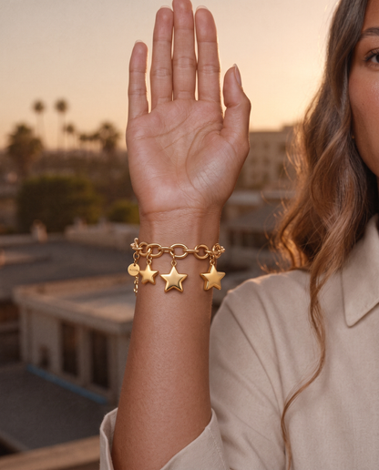 Model wearing the Celeste Star Bracelet with gold star charms, Los Angeles rooftop at sunset