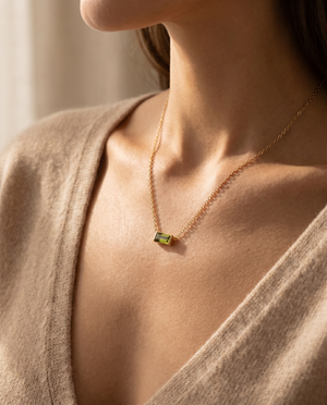 Bianca Birthstone Necklace in gold on a woman's collarbone