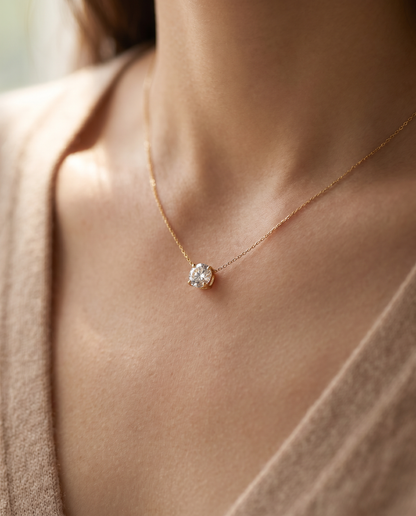 Stella Solitaire Necklace in 18k gold on a woman's collarbone