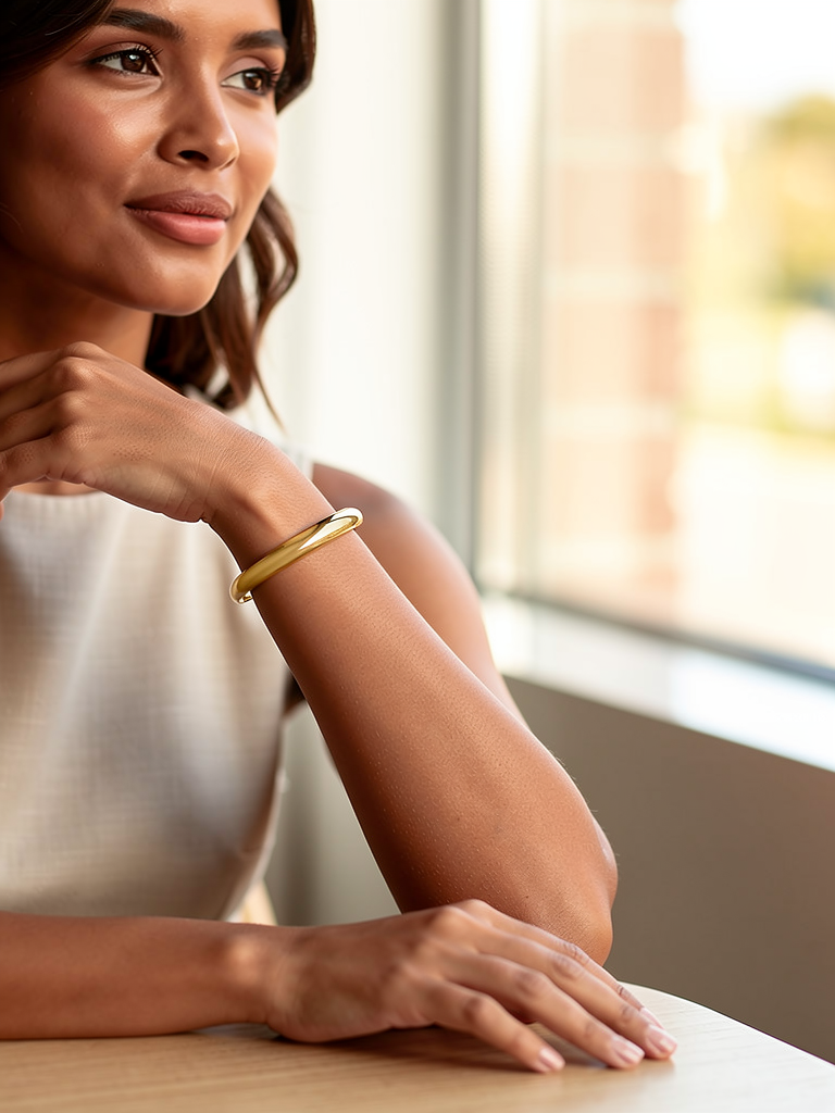 Model wearing the Sofia gold cuff bracelet on her wrist